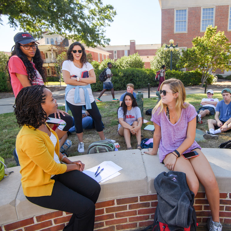 An EDHE class gathers outside on a summer day.